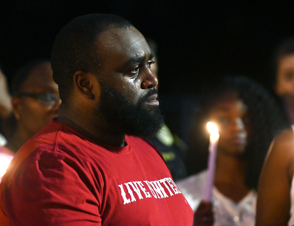 Shawntez Wells sheds tears at a vigil honoring his sister, Nadria Wright